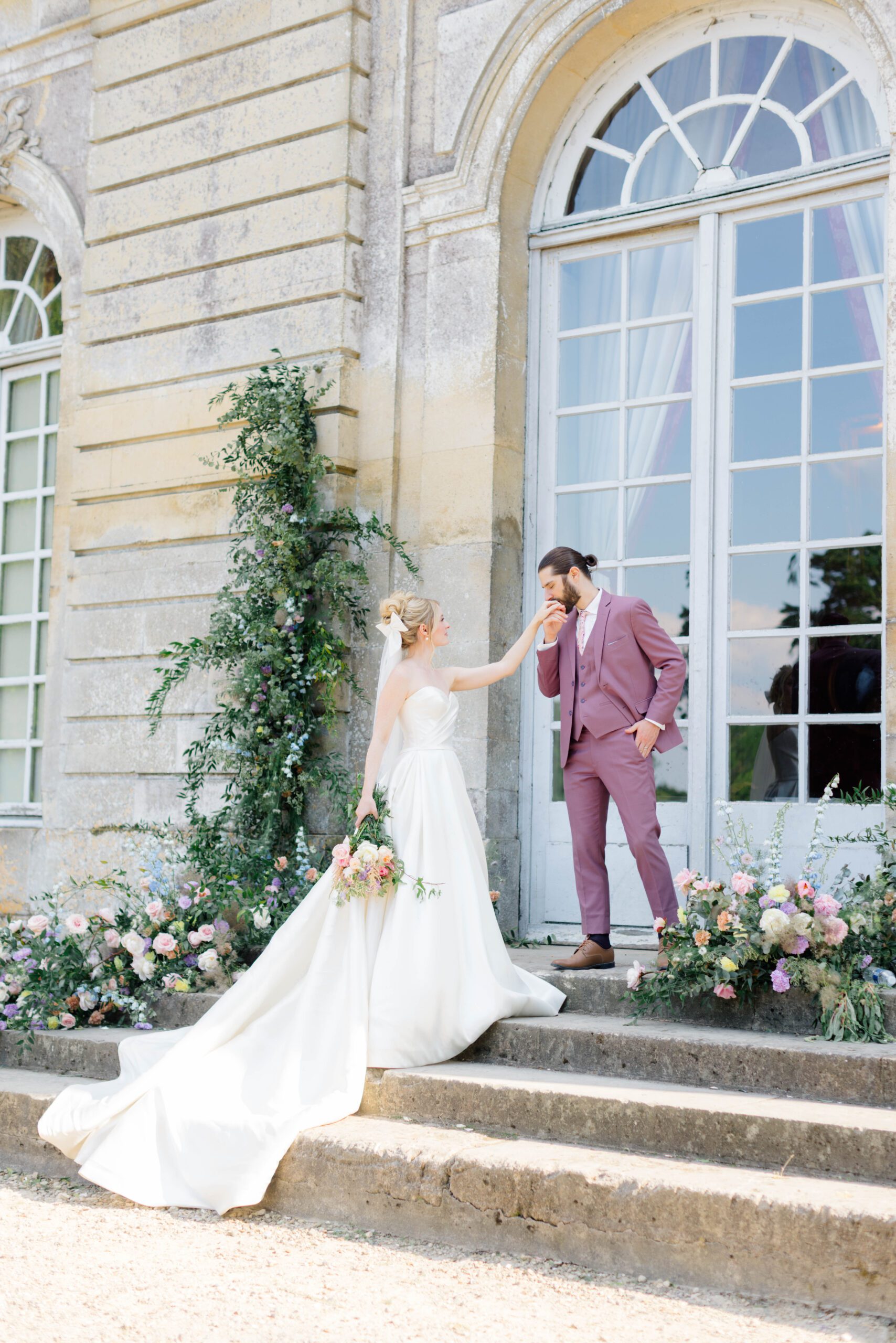 Bride and groom holding hands on stairs for outdoor wedding inspiration near Paris.