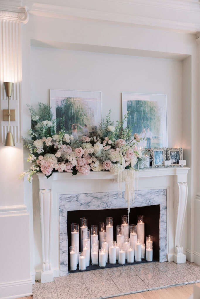 Fireplace mantel with blush florals, candles, and engagement photos at a Kimpton Cottonwood wedding