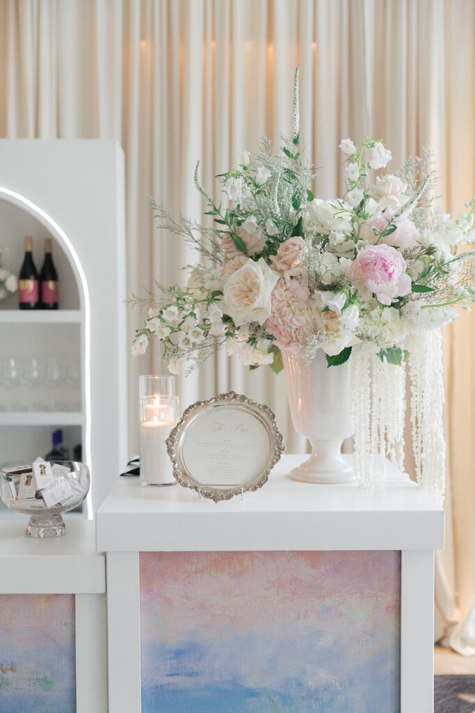 Monet-inspired water lily painted bar with blush florals at a Kimpton Cottonwood wedding cocktail hour in Omaha