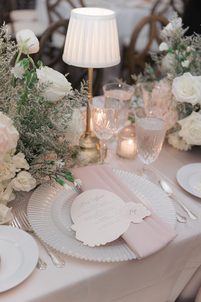 Blush place setting with a table lamp and florals at a Kimpton Cottonwood wedding dinner
