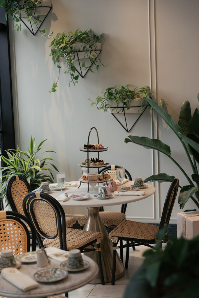 Tiered tea service on a bistro table in the Tea Room at The Kimpton Cottonwood, Omaha