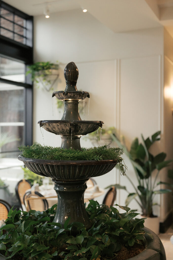 Fountain and greenery in the Tea Room at The Kimpton Cottonwood during a day-after wedding brunch