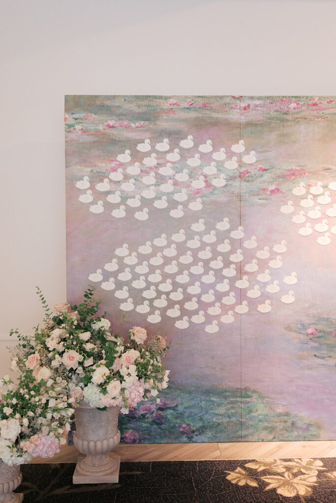 Monet-inspired water lily seating chart with swan escort cards at a Kimpton Cottonwood wedding